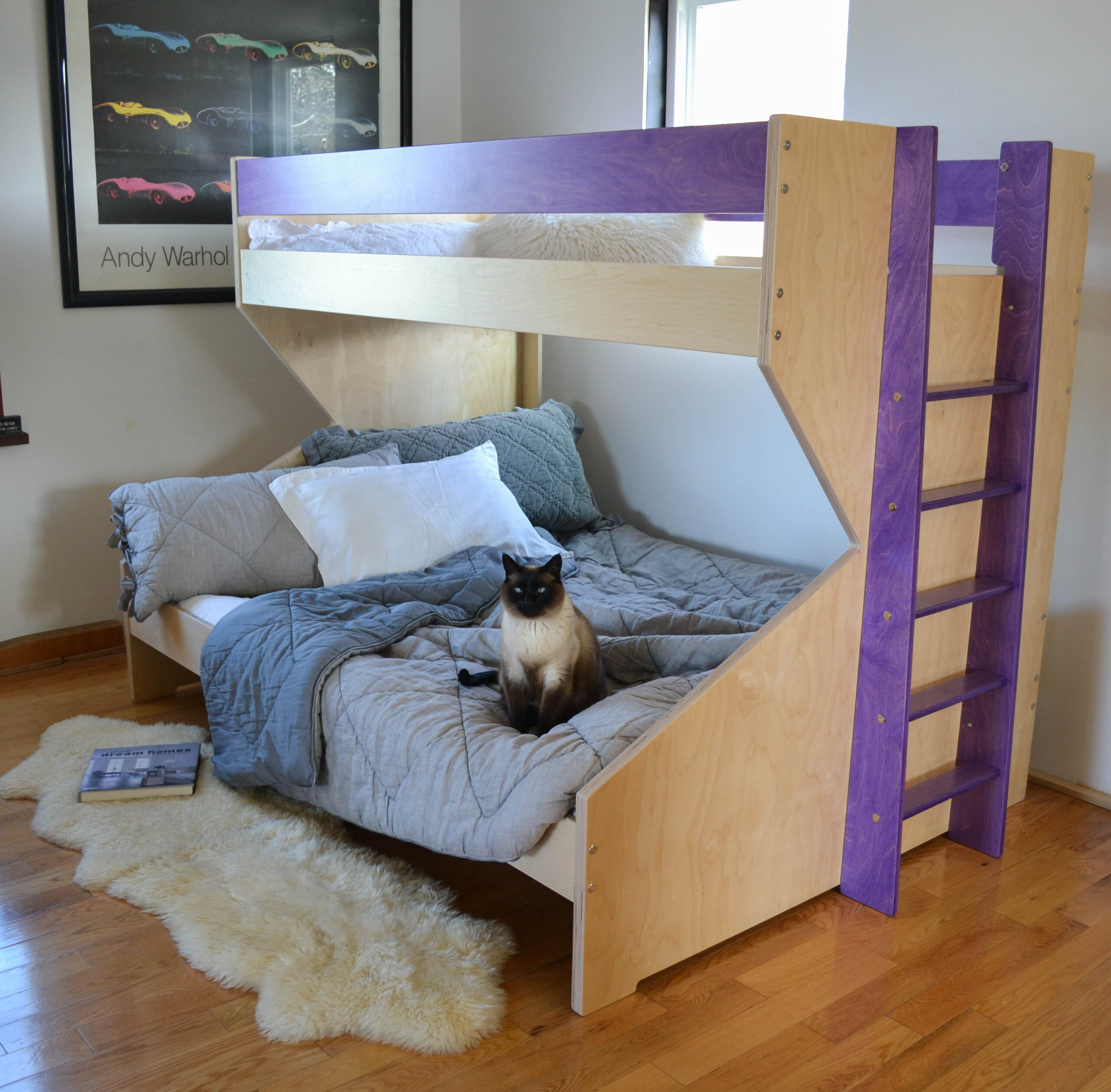 z bed with purple accents and a siamese cat sitting on the bed, made out of birch multiply and finished in an eco friendly varnish
